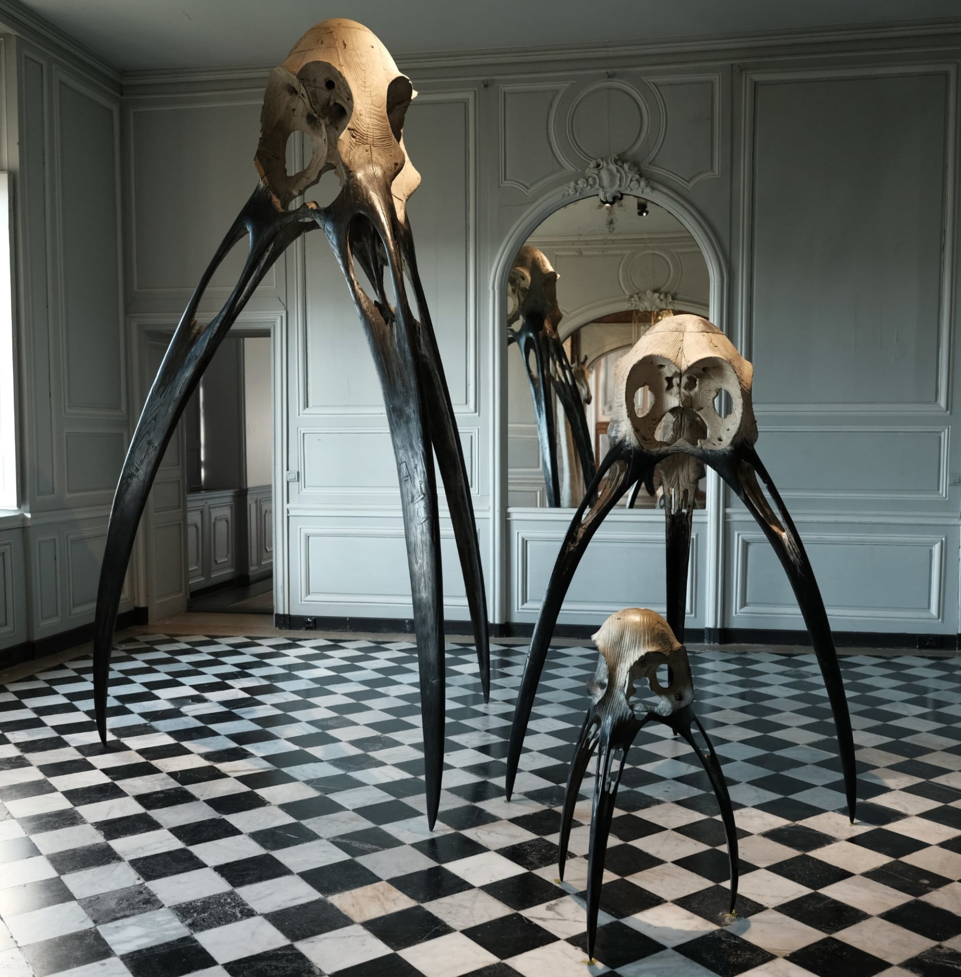 A photo of oversized sculptures of skeletal forms